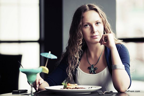 Beautiful young woman dining at a restaurant