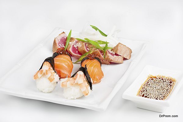 The sashimi plate with shrimps, salmon and tuna
