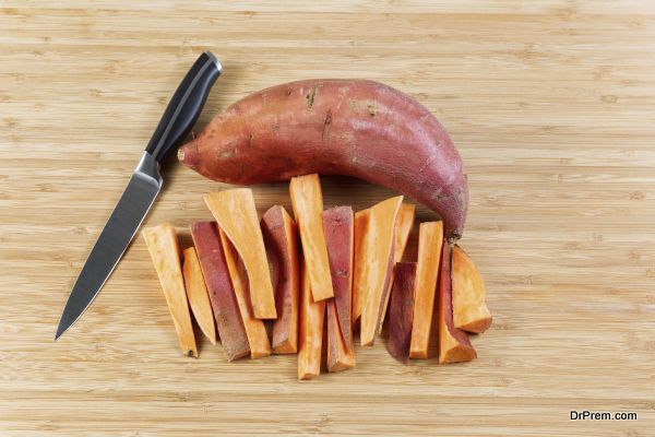 Fresh Yams sliced on Bamboo cutting board