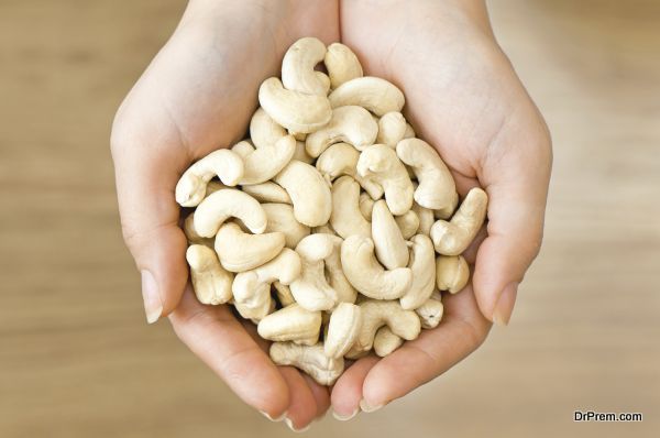 Ripe cashew nuts in woman's hands