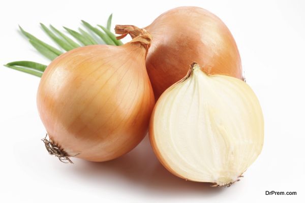 Fresh bulbs of onion on a white background