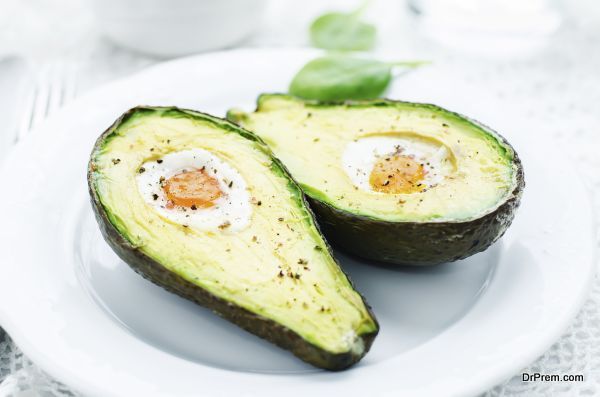 avocado baked with egg on a white background. tinting. selective focus