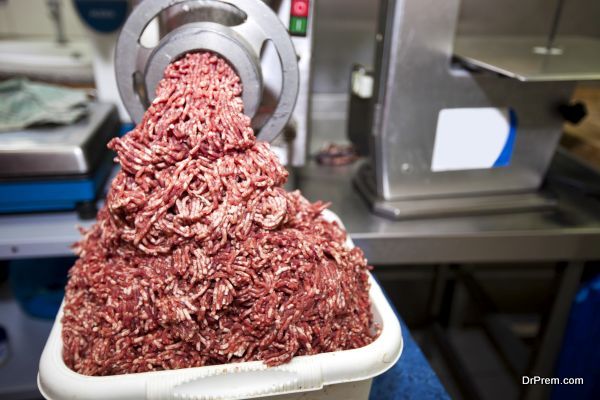 Machine mincing meat in grocery store