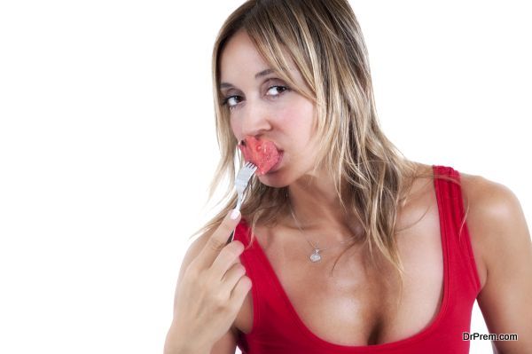woman eating at a piece juicy watermelon