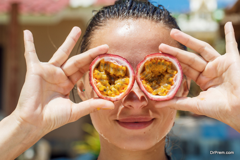 beautiful girl on the beach with passion fruit for eyes in Thailand