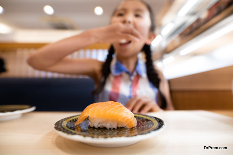 A child eating salmon sushi
